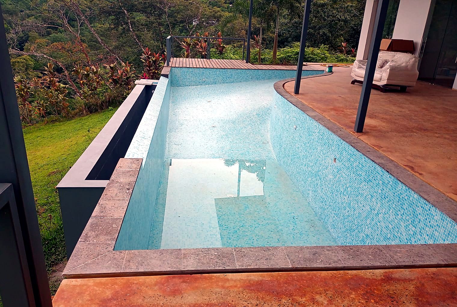 Mosaic-tiled pool & stained concrete deck